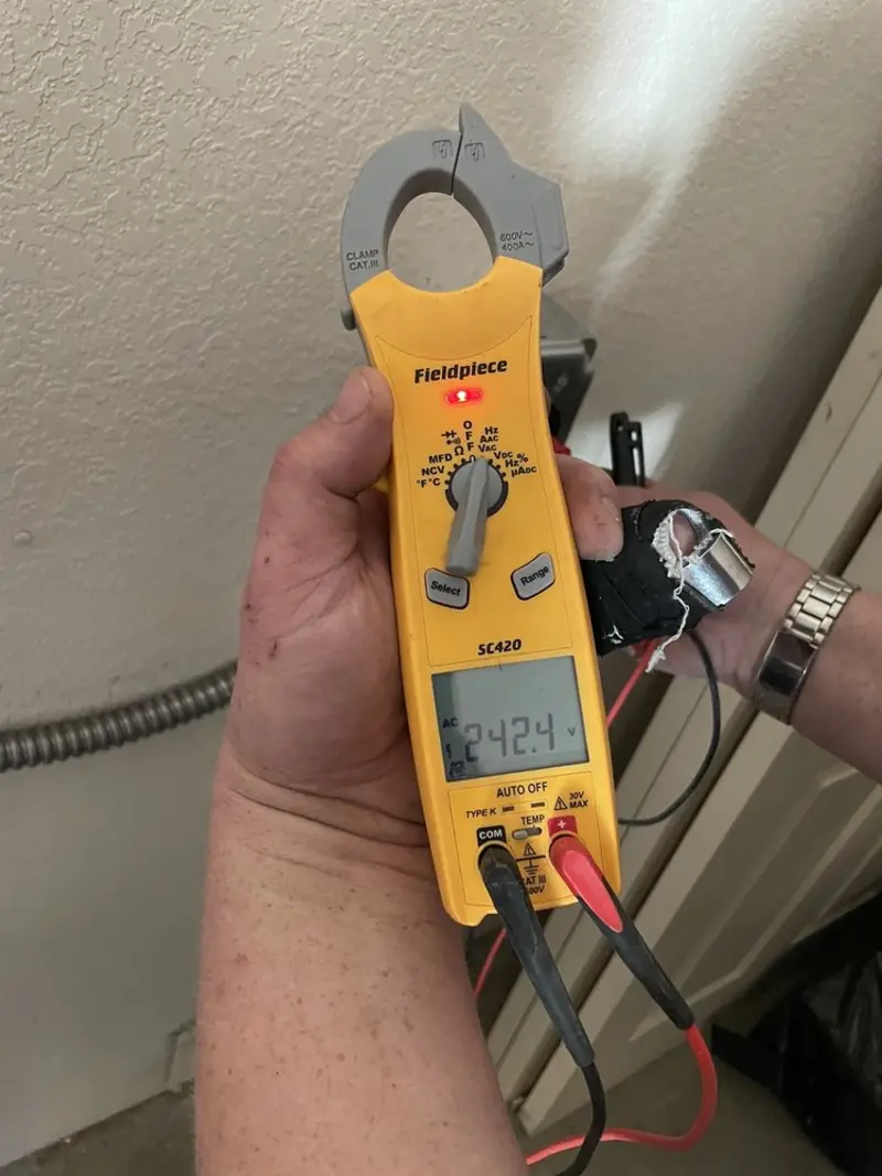Voltage testing with clamp meter during Recessed Lighting Installation in Emma